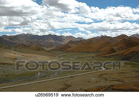 Stock Photo - View of pathway amid mountains.. Fotosearch