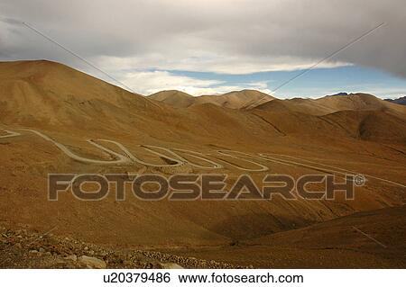 Stock Photograph - View of pathway amid mountains.. Fotosearch