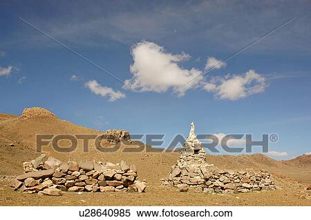 Stock Photography - View of piled stones on a barren land.. Fotosearch