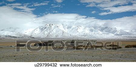 Stock Image - View of structures under cloudy sky.. Fotosearch