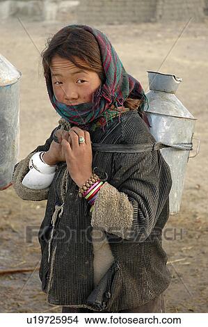 View of woman carrying milk can. View Large Photo Image Picture - View of woman carrying milk can.. Fotosearch