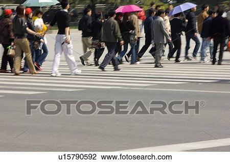 Stock Image - China, Beijing, Pedestrians walking on sidewalk. Fotosearch