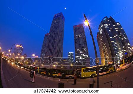 Stock Image - China, Beijing, Skyscrapers and busy street in night. Fotosearch