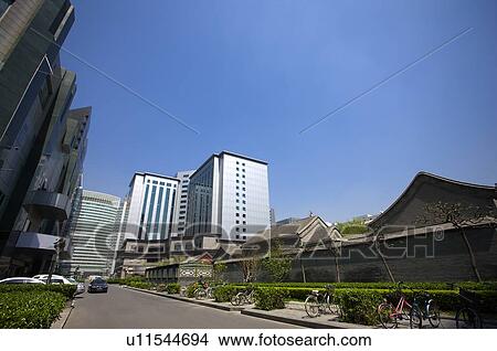 Picture - Old houses locating among the modern buildings. Fotosearch