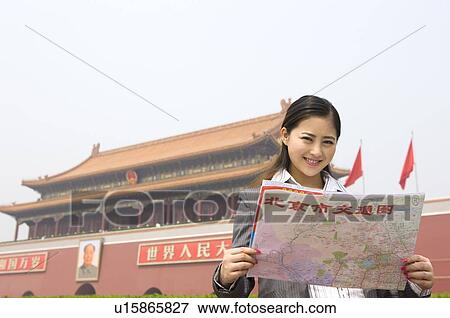Young woman looking at map View Large Photo Image Stock Photo - Young woman looking at map. Fotosearch