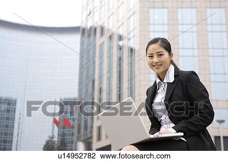 Young woman using laptop View Large Photo Image Stock Image - Young woman using laptop. Fotosearch