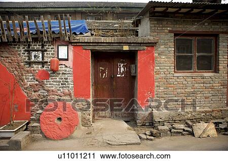 Stock Image - China, Beijing, A gate of ordinary brick house. Fotosearch
