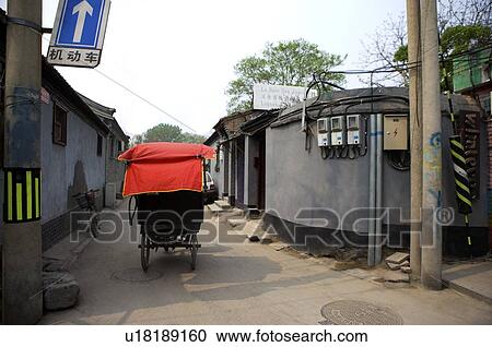 Stock Image - Rickshaw running on hutong. Fotosearch