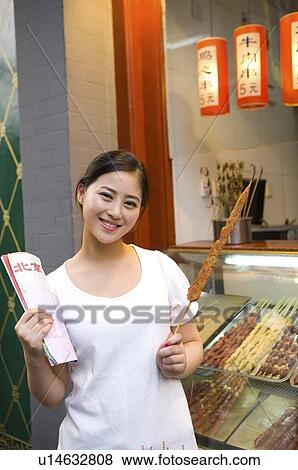 Young woman holding map and Kebab View Large Photo Image Stock Photo - Young woman holding map and Kebab. Fotosearch
