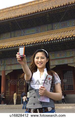 Young woman photographing herself at Forbidden City View Large Photo Image Stock Image - Young woman photographing herself at Forbidden City. Fotosearch