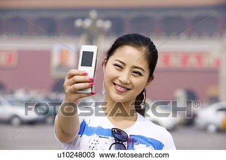 Young woman photographing herself in front of Tiananmen Square View Large Photo Image Stock Image - Young woman photographing herself in front of Tiananmen Square. Fotosearch