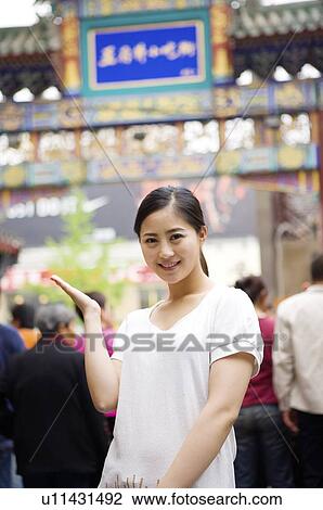 Young woman posing in front of wangfujing snack street View Large Photo Image Stock Image - Young woman posing in front of wangfujing snack street. Fotosearch