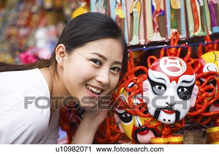 Young woman with Chinese opera mask View Large Photo Image Stock Image - Young woman with Chinese opera mask. Fotosearch