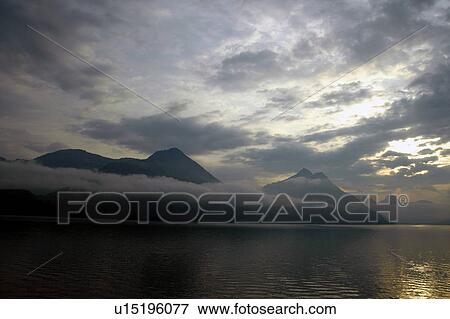 Stock Photo - mountain, cloud, lake, Europe, cloudy, mountains, abenddaemmerung. Fotosearch