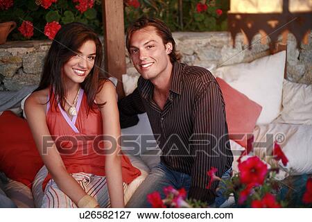 Stock Photo - Couple posing on couch. Fotosearch