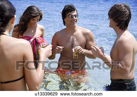Group of friends in water having fun View Large Photo Image Stock Photo - Group of friends in water having fun. Fotosearch