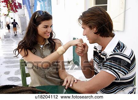 Stock Image - Man kissing woman's hand. Fotosearch