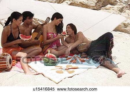 Two couples on beach having fun View Large Photo Image Stock Photography - Two couples on beach having fun. Fotosearch