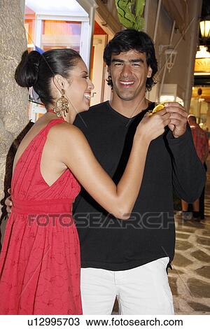 Stock Image - Young couple with shot glasses. Fotosearch