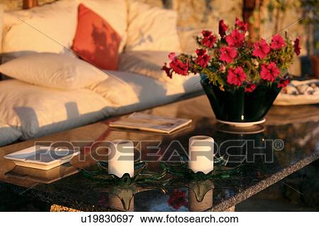 Stock Photo - Couch and table in outdoor garden. Fotosearch