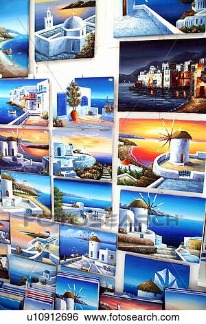 Stock Photograph - Island paintings displayed for sale. Fotosearch