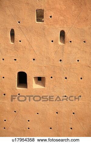 Stock Photo - Closeup of building wall with holes. Fotosearch