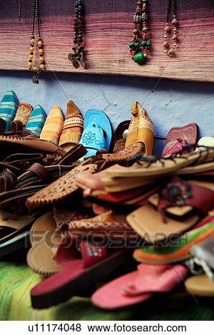 Stock Photo - Moroccan slippers and necklaces for sale. Fotosearch
