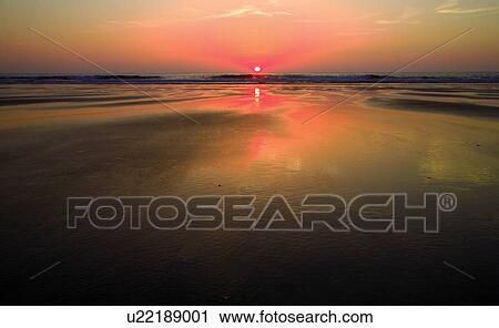 Stock Image - View of sunset over water. Fotosearch