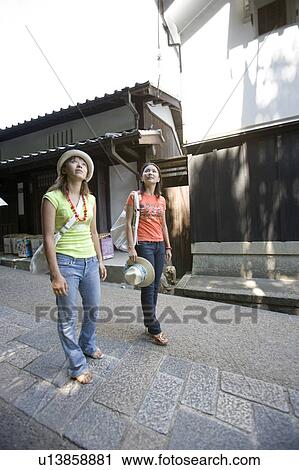 Two young women looking up View Large Photo Image Stock Image - Two young women looking up. Fotosearch