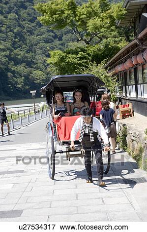 Two young women sitting in rickshaw View Large Photo Image Stock Photo - Two young women sitting in rickshaw. Fotosearch