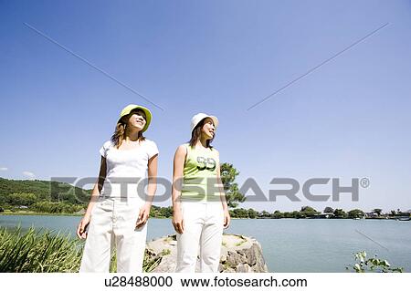 Two young women standing by Hirosawa Pond, Kyoto, Japan View Large Photo Image Stock Image - Two young women standing by Hirosawa Pond, Kyoto, Japan. Fotosearch