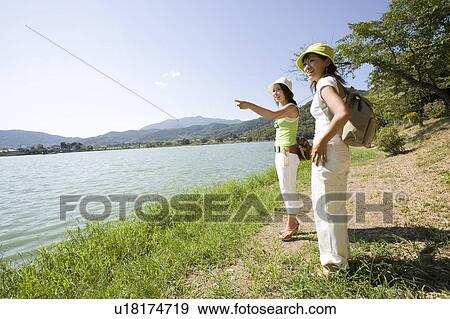 Two young women standing by Hirosawa Pond, Kyoto, Japan View Large Photo Image Stock Photo - Two young women standing by Hirosawa Pond, Kyoto, Japan. Fotosearch