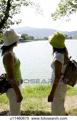 Two young women standing by Hirosawa Pond, Kyoto, Japan View Large Photo Image Stock Photography - Two young women standing by Hirosawa Pond, Kyoto, Japan. Fotosearch