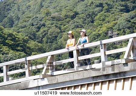 Two young women standing on togetsu bridge in Arashiyama, Kyoto, Japan View Large Photo Image Stock Photo - Two young women standing on togetsu bridge in Arashiyama, Kyoto, Japan. Fotosearch