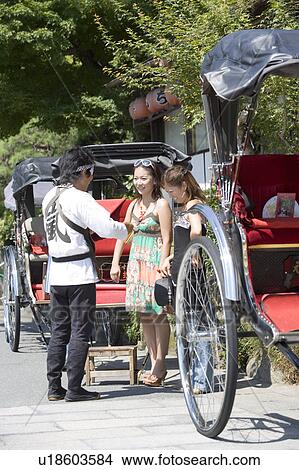 Two young women talking with rickshaw driver View Large Photo Image Picture - Two young women talking with rickshaw driver. Fotosearch