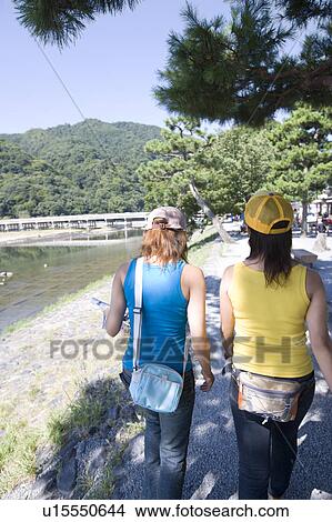 Two young women walking in Arashiyama, Kyoto, Japan View Large Photo Image Picture - Two young women walking in Arashiyama, Kyoto, Japan. Fotosearch