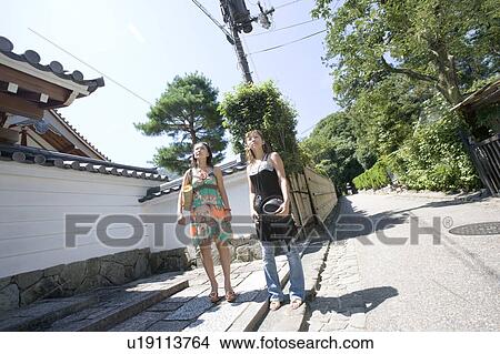 Two young women walking in Sagano, Kyoto, Japan View Large Photo Image Picture - Two young women walking in Sagano, Kyoto, Japan. Fotosearch