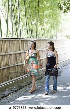 Two young women walking in Sagano, Kyoto, Japan View Large Photo Image Stock Photo - Two young women walking in Sagano, Kyoto, Japan. Fotosearch