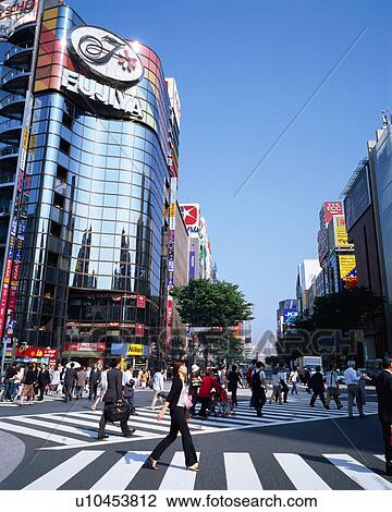 Stock Image - People crossing street in Ginza, Tokyo, Japan. Fotosearch