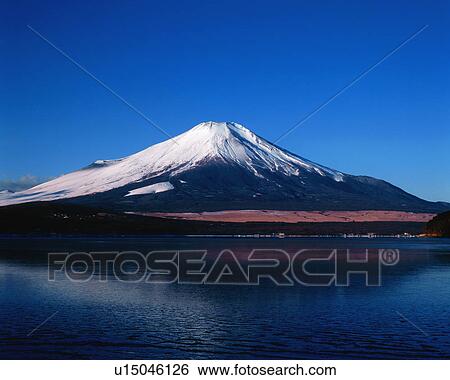 Stock Photograph - Mt. Fuji reflected on lake. Fotosearch