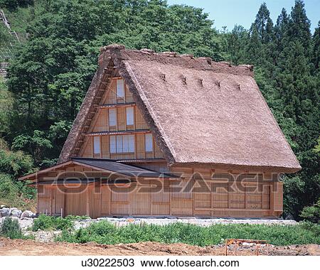 Stock Image - Straw roof house. Fotosearch