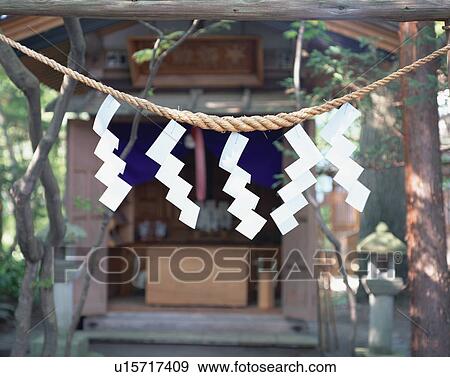 Stock Photo - Straw rope in front of shrine. Fotosearch