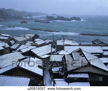 Stock Photo - Snow covered houses in Sado, Niigata, Japan. Fotosearch
