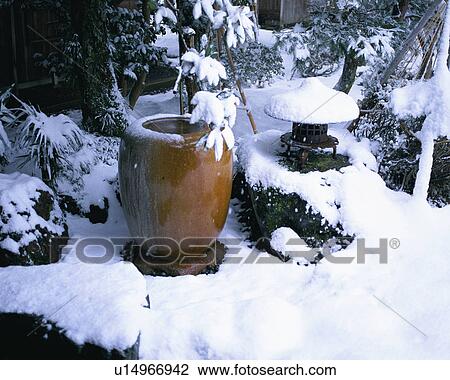 Stock Image - Snow covered washing bowl and lamp. Fotosearch