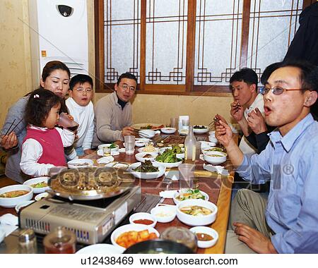 People eating in a Korean restaurant View Large Photo Image Stock Photo - People eating in a Korean restaurant. Fotosearch