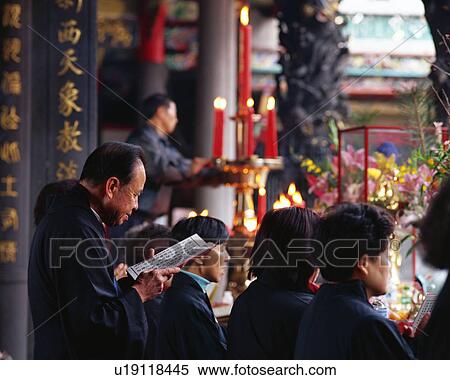 Stock Photography - People praying at temple. Fotosearch