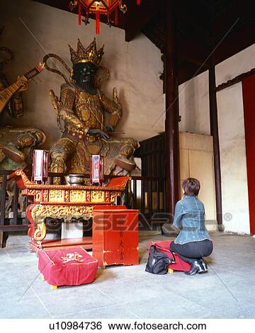 A young woman praying in temple View Large Photo Image Stock Photograph - A young woman praying in temple. Fotosearch