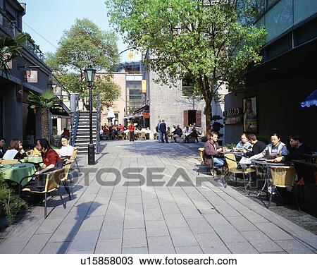 Stock Image - People relaxing at coffee shops in Shanghai, China. Fotosearch