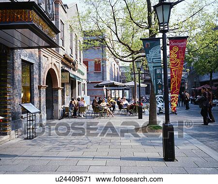 Stock Image - People relaxing at coffee shops in Shanghai, China. Fotosearch