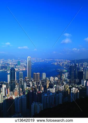 Stock Photo - China, Hong Kong, skyscrapers and harbor, day, aerial view. Fotosearch